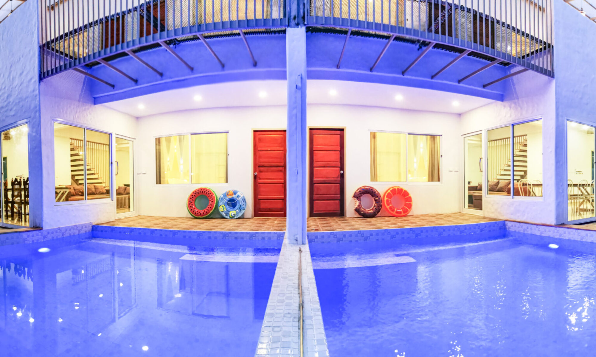 Unique joined villa setup at Thepprasit Cosy Twin Villas A & B connected into one spacious home with illuminated pool, vibrant interiors, and room for large gatherings.