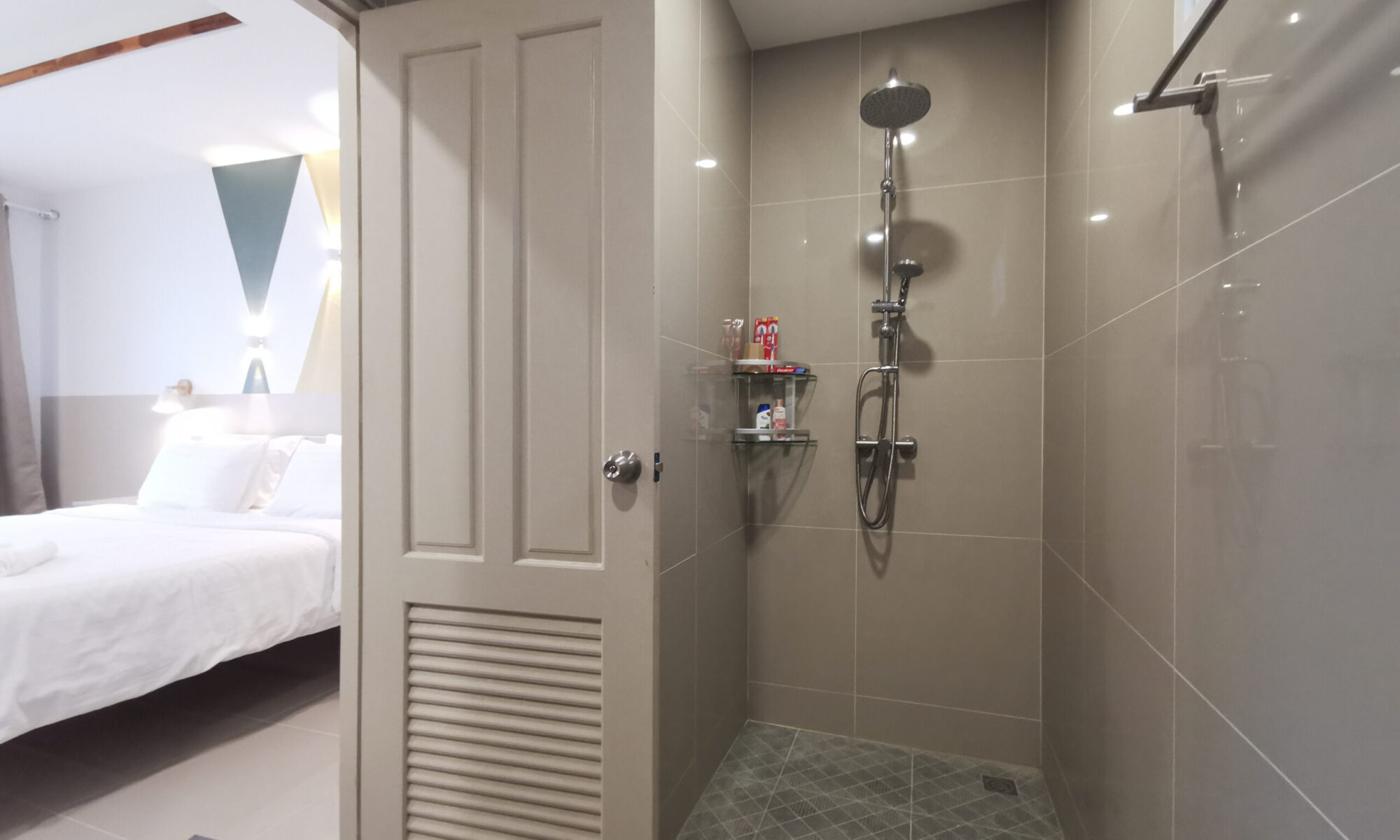 Modern ensuite bathroom opening into a serene bedroom at Thepprasit Cosy Twin where comfort and convenience meet in a sunlit retreat.